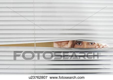 Woman Looking Through Venetian Blinds front view. View Large Photo Image Stock Photo - Woman Looking Through Venetian Blinds front view.. Fotosearch