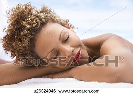 Woman lying on massage table head and shoulders eyes closed View Large Photo Image Stock Photograph - Woman lying on massage table head and shoulders eyes closed. Fotosearch