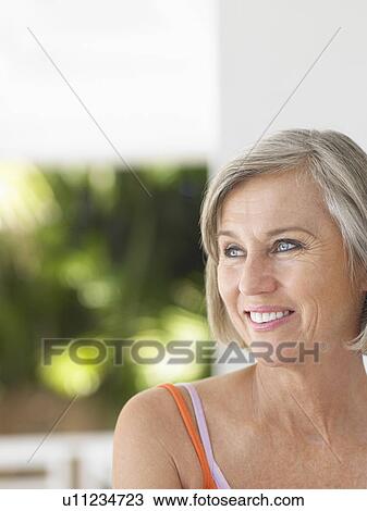 Stock Image - Woman on verandah portrait. Fotosearch