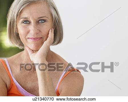 Stock Image - Woman on verandah portrait. Fotosearch