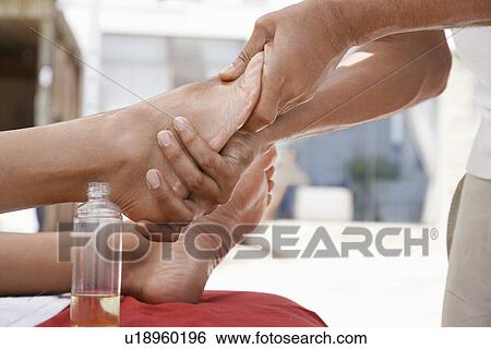 Woman receiving foot massage low section close up of feet View Large Photo Image Stock Photograph - Woman receiving foot massage low section close up of feet. Fotosearch