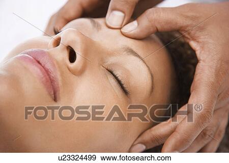Woman receiving massage close-up of face View Large Photo Image Stock Photo - Woman receiving massage close-up of face. Fotosearch