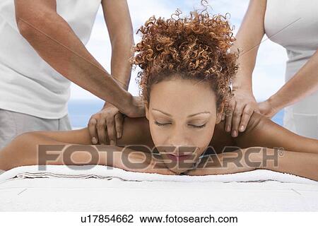 Woman receiving massage from two people head and shoulders eyes closed View Large Photo Image Stock Image - Woman receiving massage from two people head and shoulders eyes closed. Fotosearch