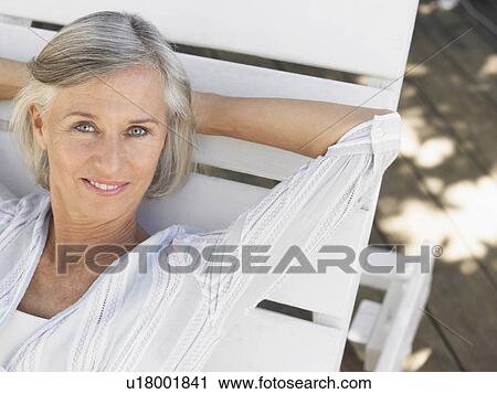 Woman reclining on sun lounger elevated view portrait View Large Photo Image Stock Image - Woman reclining on sun lounger elevated view portrait. Fotosearch