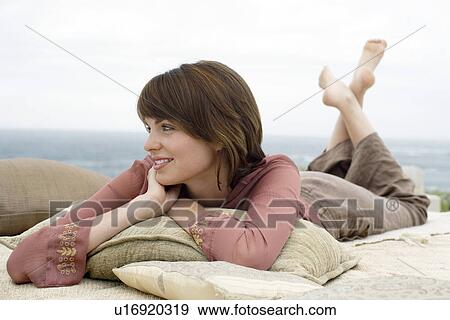 Woman relaxing by beach View Large Photo Image Stock Photo - Woman relaxing by beach. Fotosearch