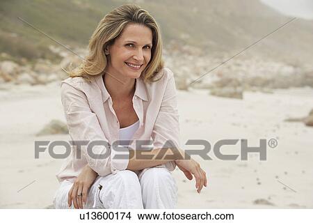 Picture - Woman Relaxing on Beach. Fotosearch