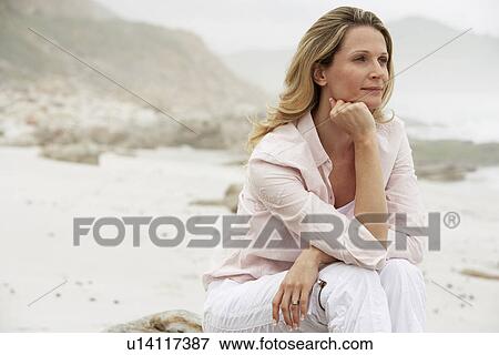 Stock Photo - Woman Relaxing on Beach. Fotosearch