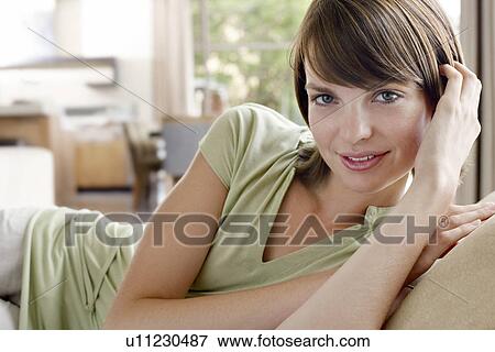 Woman resting on sofa portrait View Large Photo Image Stock Photo - Woman resting on sofa portrait. Fotosearch