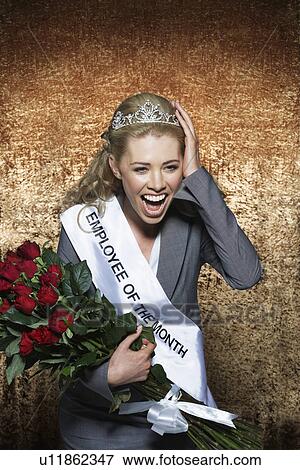 Woman screaming wearing Employee of the Month pageant paraphernalia against gold velvet background View Large Photo Image Stock Photo - Woman screaming wearing Employee of the Month pageant paraphernalia against gold velvet background. Fotosearch