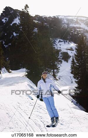 Stock Photo - Woman skiing down slope elevated view. Fotosearch
