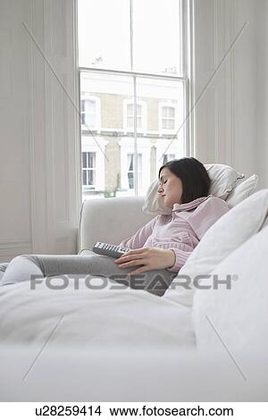 Picture - Woman sleeping on sofa. Fotosearch