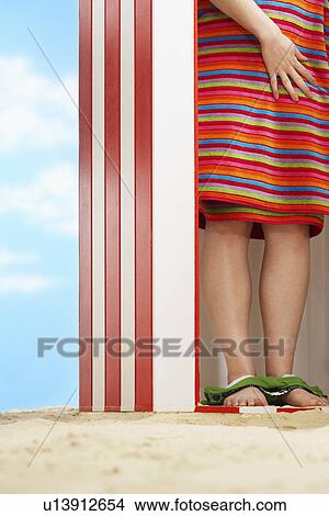 Woman standing in beach change cabin low section View Large Photo Image Picture - Woman standing in beach change cabin low section. Fotosearch