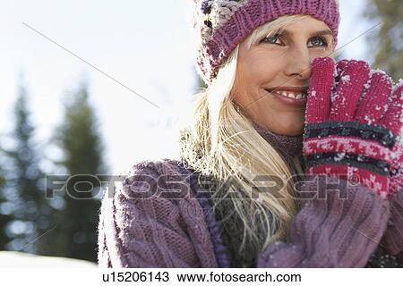 Stock Image - Woman wearing winter clothing smiling portrait. Fotosearch
