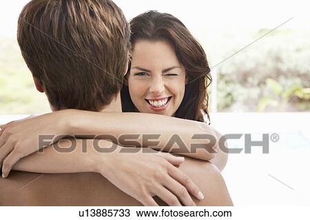 Woman winking over man's shoulder head and shoulders View Large Photo Image Stock Image - Woman winking over man's shoulder head and shoulders. Fotosearch