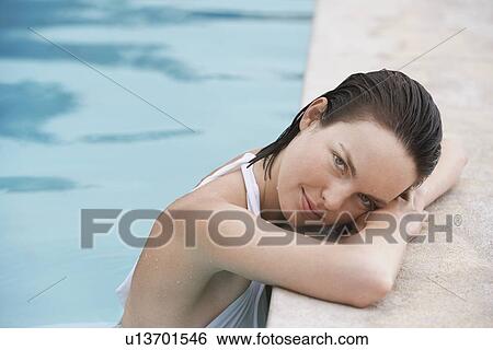 Women resting in swimming pool portrait View Large Photo Image Stock Photograph - Women resting in swimming pool portrait. Fotosearch