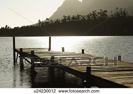 Stock Image - Wooden dock on lake.. Fotosearch