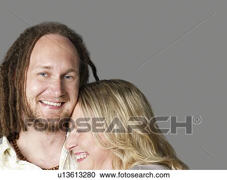 Stock Image - Young couple cuddling close-up. Fotosearch