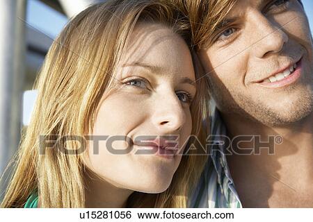 Young couple embracing head and shoulders View Large Photo Image Stock Photograph - Young couple embracing head and shoulders. Fotosearch