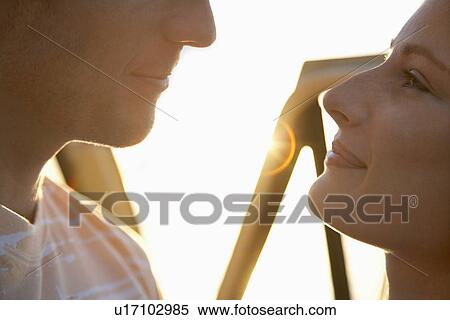 Stock Photography - Young couple face to face close up. Fotosearch