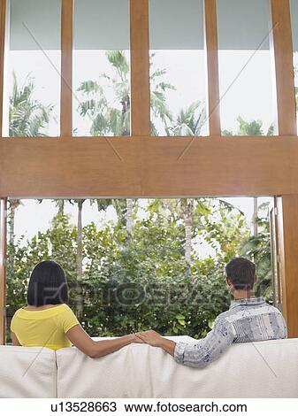 Young Couple Holding Hands on Sofa View Large Photo Image Stock Image - Young Couple Holding Hands on Sofa. Fotosearch
