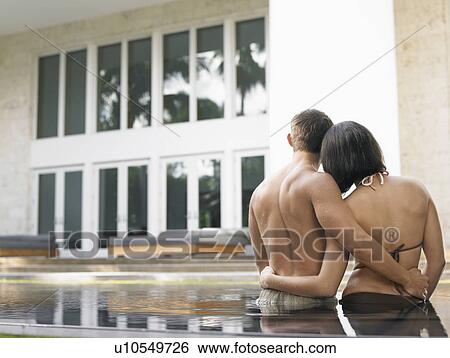 Stock Photograph - Young Couple in Swimming Pool. Fotosearch