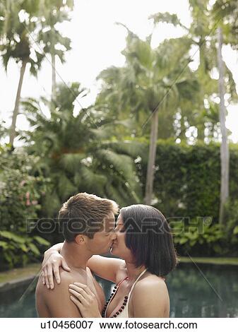 Young Couple Kissing in Garden View Large Photo Image Stock Photo - Young Couple Kissing in Garden. Fotosearch