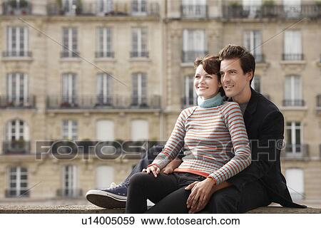 Stock Photo - Young couple posing on bridge in front of town houses. Fotosearch