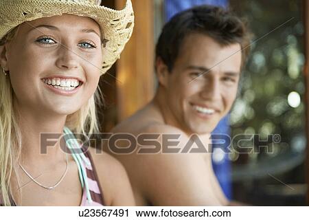 Stock Image - Young couple smiling head and shoulders. Fotosearch