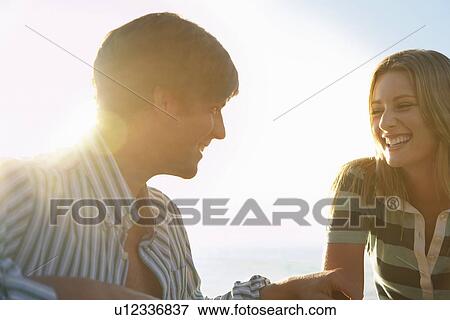 Stock Photo - Young couple smiling head and shoulders. Fotosearch