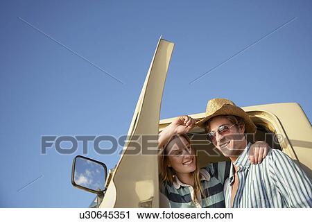 Young couple standing in doorway to van head and shoulders View Large Photo Image Stock Image - Young couple standing in doorway to van head and shoulders. Fotosearch