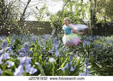 Young girl (5-6) running in flower garden wearing fairy costume motion blur View Large Photo Image Stock Image - Young girl (5-6) running in flower garden wearing fairy costume motion blur. Fotosearch