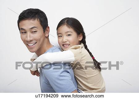 Stock Photo - Young Girl Getting Piggyback Ride with Father side view. Fotosearch