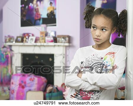 Young Girl leaning against door arms crossed Showing Attitude View Large Photo Image Stock Image - Young Girl leaning against door arms crossed Showing Attitude. Fotosearch