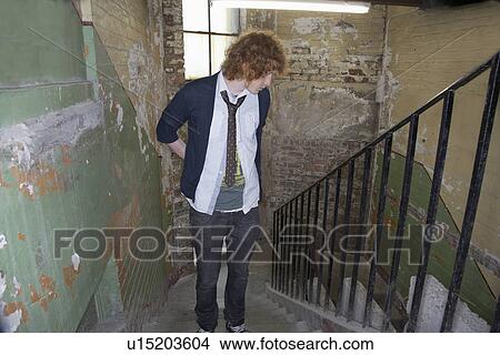 Young man in old dilapidated building View Large Photo Image Picture - Young man in old dilapidated building. Fotosearch