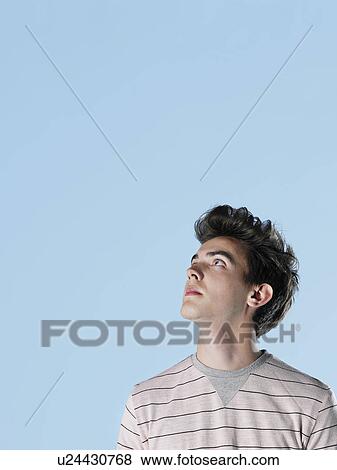 Stock Photo - Young man looking up. Fotosearch
