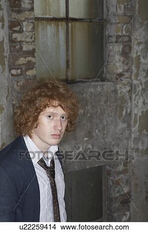 Picture - Young man outside old building. Fotosearch
