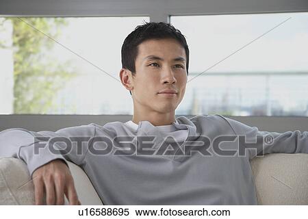 Young Man Relaxing on Sofa View Large Photo Image Stock Photography - Young Man Relaxing on Sofa. Fotosearch