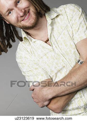 Young man smiling arms crossed View Large Photo Image Stock Photo - Young man smiling arms crossed. Fotosearch