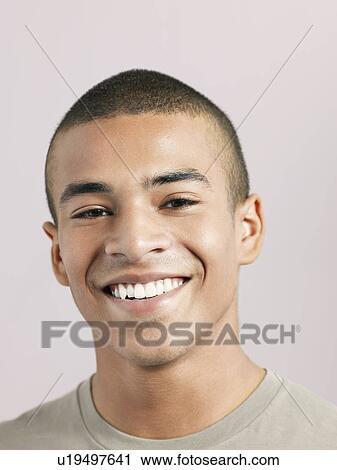 Stock Image - Young man smiling close-up. Fotosearch