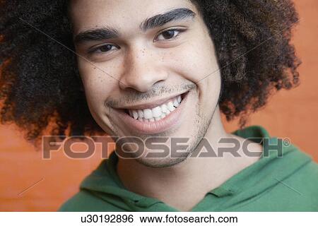 Stock Photograph - Young man smiling close-up. Fotosearch