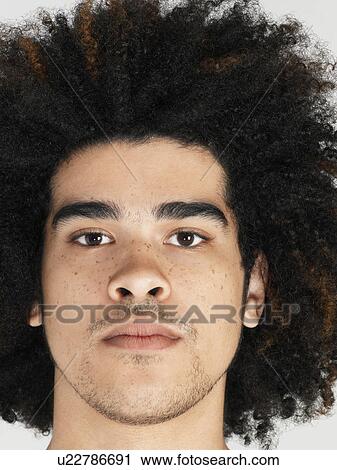 Stock Image - Young man with afro close-up. Fotosearch