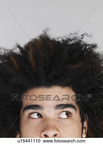 Young man with afro looking up high section View Large Photo Image Stock Image - Young man with afro looking up high section. Fotosearch