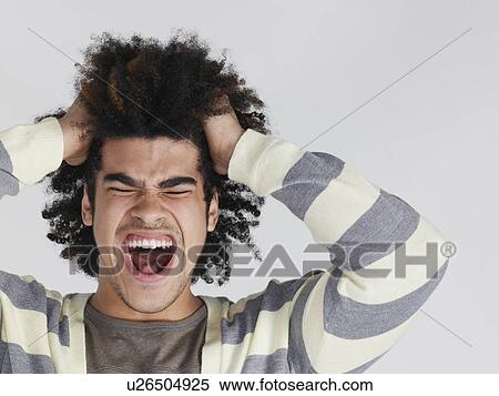 Young man with head in hands screaming View Large Photo Image Stock Photography - Young man with head in hands screaming. Fotosearch
