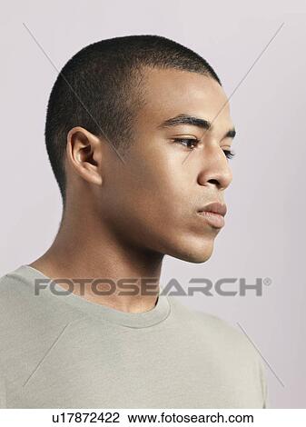 Stock Image - Young pensive man close-up. Fotosearch