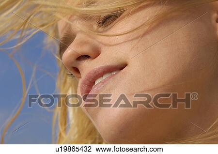 Young woman close-up low angle view View Large Photo Image Stock Image - Young woman close-up low angle view. Fotosearch