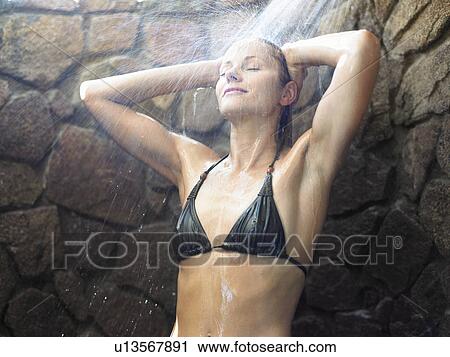 Young woman having shower outdoors View Large Photo Image Stock Image - Young woman having shower outdoors. Fotosearch