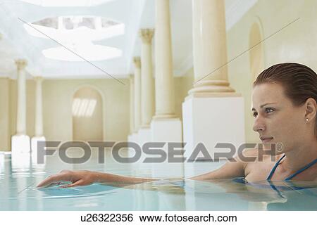 Young woman in swimming pool portrait View Large Photo Image Stock Photograph - Young woman in swimming pool portrait. Fotosearch