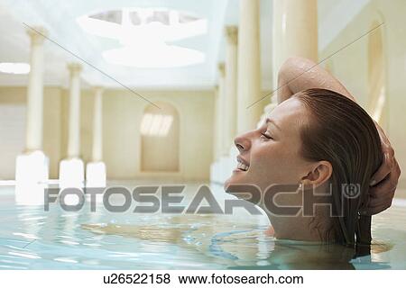 Young woman in swimming pool with hand on head profile View Large Photo Image Stock Photo - Young woman in swimming pool with hand on head profile. Fotosearch