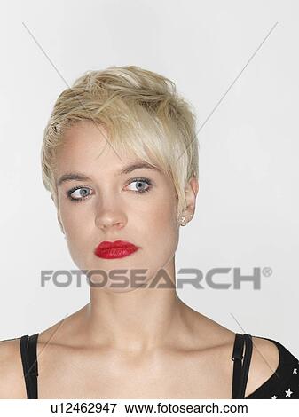 Stock Photo - Young woman looking away close-up. Fotosearch