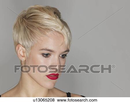 Stock Photo - Young woman looking down close-up. Fotosearch